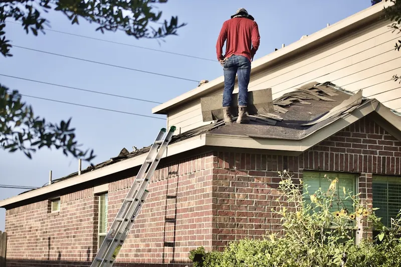 Professional roofer working on a residential roof in Borger